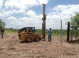 The Model 40 on a John Deere skid steer, driving pipe in the ground.