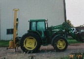 Black Cat Hyrdraulic Fence Post Driver - Model 40 on a John Deere tractor.