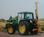 Black Cat Fence Post Driver - Model 40 on a John Deere tractor.